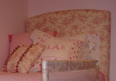 custom upholstered headboard, pillows and bed rail.