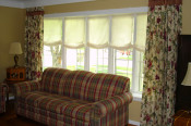 pleated drapery panels with roman shades