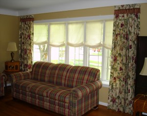 pleated drapery panels with roman shades